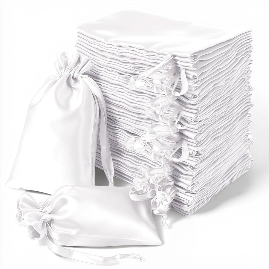 White satin drawstring bags stacked in a neat pile.