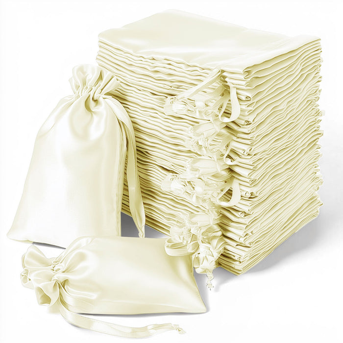 Stack of elegant cream satin gift bags with drawstring closures