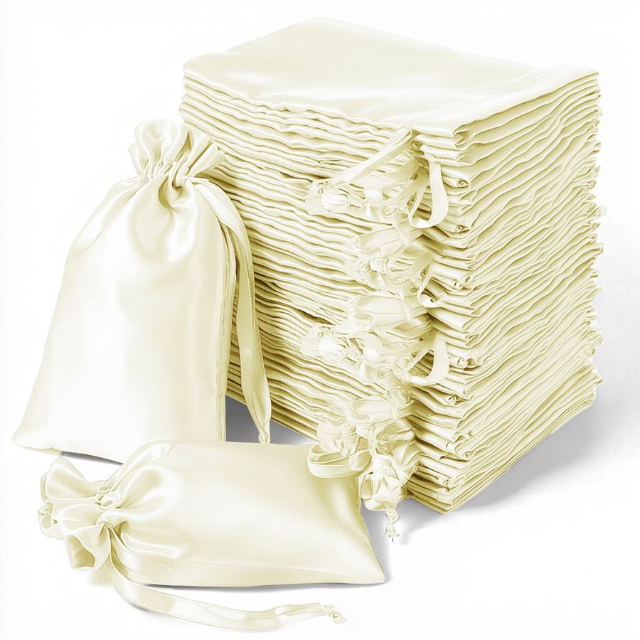 Stack of elegant cream satin gift bags with drawstring closures