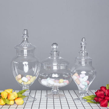 Set of 3 Glass Candy Jars Pedestal Apothecary Design Clear with Snap-On Lids - Stylish Party Favor Containers 10"/12"/14"