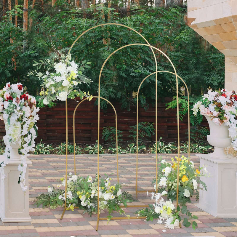 Gold wedding arch with floral arrangements