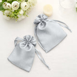 Silver satin drawstring bags for elegant gift packaging.