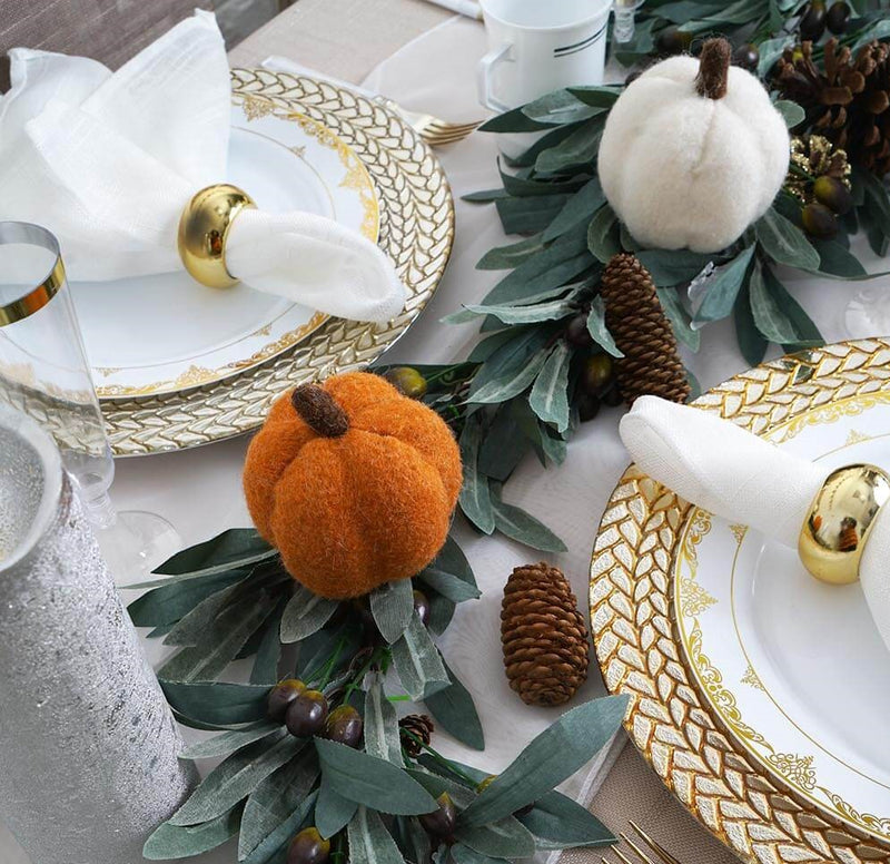 Close-up of orange and white pumpkins on fall tablescape