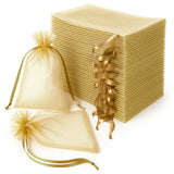 Golden organza bags and sheets stacked on a white background.