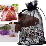 Organza gift bags with colorful decorations and assorted embellishments.