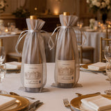 Elegant wine bottles in decorative bags on a beautifully set dining table.