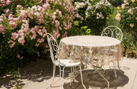 Sheer lace tablecloth on patio table and chairs