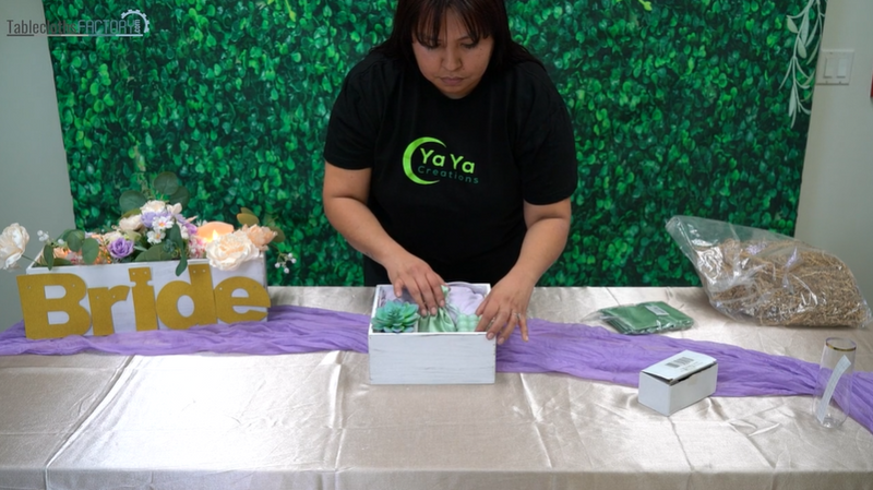 Woman setting up party favor gifts inside the planter box