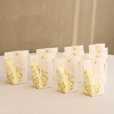 Elegant gold-foiled rose gift bags arranged on a neutral background.