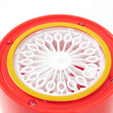 Red circular container with intricate white design on top.