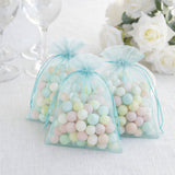 Pastel-colored candy bags for party favors on a table with elegant decor.