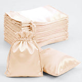 Satin drawstring bags in various sizes stacked on a light background.