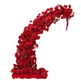 Red floral arch arrangement made of roses and blooms on a white background.