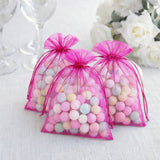 Colorful candy-filled favor bags tied with pink ribbons.