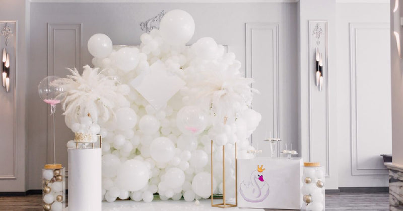 White balloon wedding backdrop with gold accents