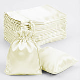 Set of silk drawstring bags in cream color, ideal for gifting and storage.