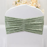 Green velvet chair cover with pleated design for elegant decor.