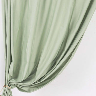 Green draped fabric on a white background