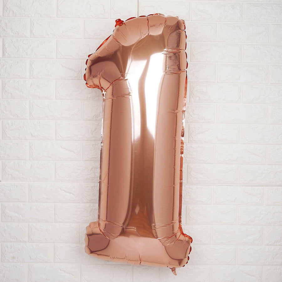 Rose gold number 1 balloon decoration for birthday celebrations.