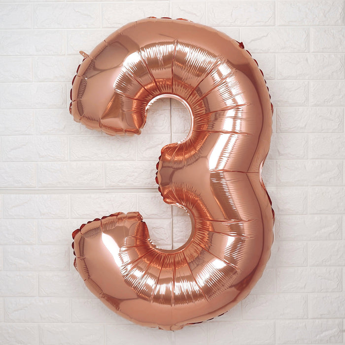 Rose gold number 3 balloon on a white background