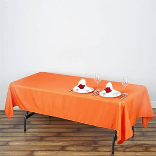 Brighten Up Your Event with the Vibrant Orange 60x102 Seamless Polyester Rectangular Tablecloth
