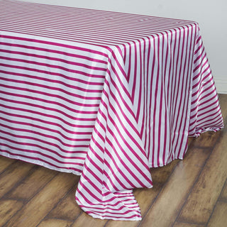 Add Elegance to Your Event with the White/Fuchsia Seamless Stripe Satin Rectangle Tablecloth