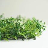 Artificial greenery wreath with white flowers and ferns
