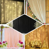 Decorative backdrop curtains with fairy lights for events and photography.