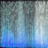 Illuminated curtain backdrop with sparkling lights in blue and white hues.