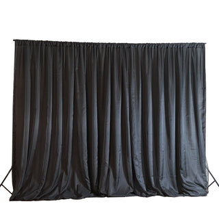 Black fabric backdrop for photography or events.