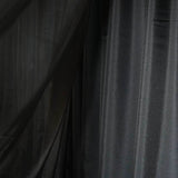 Black sheer fabric draped elegantly in soft folds. #whtbkgd