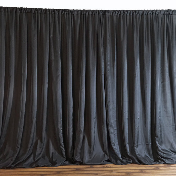 Black satin curtain draped elegantly, adding a touch of sophistication to any space.