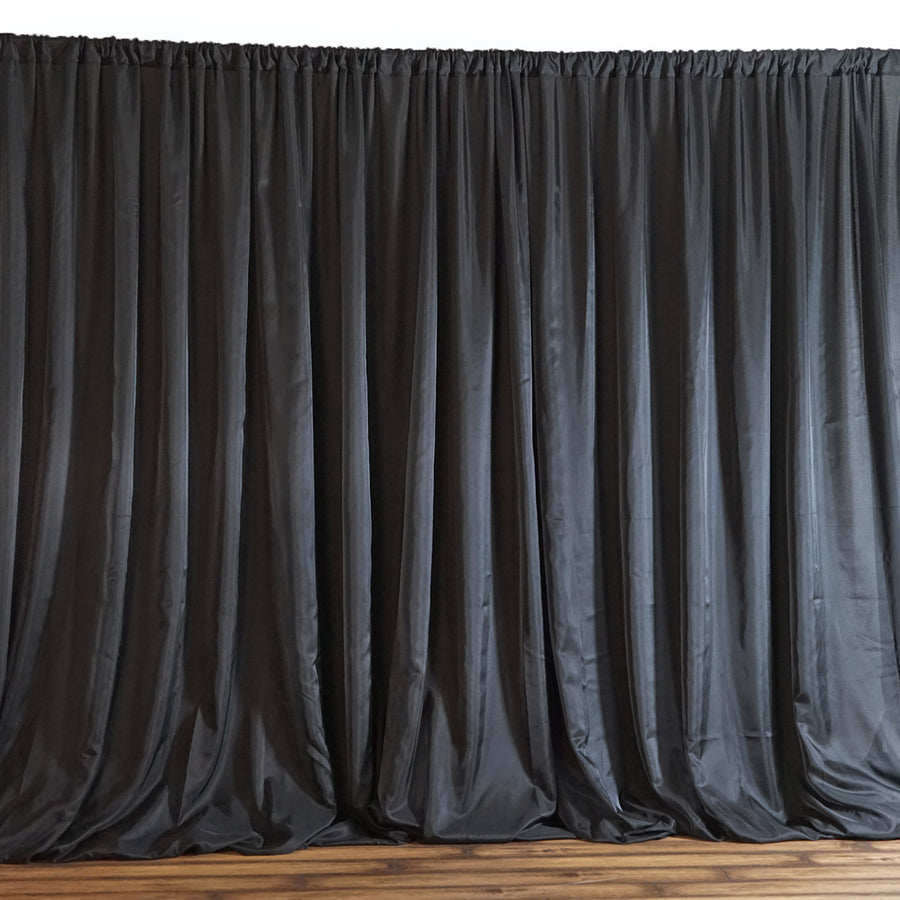 Black satin curtain draped elegantly, adding a touch of sophistication to any space.
