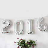 Silver foil balloons spelling "2016" with decorative flowers below.