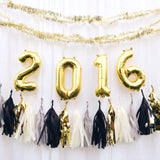 Gold 2016 balloon decoration with black and white tassels.