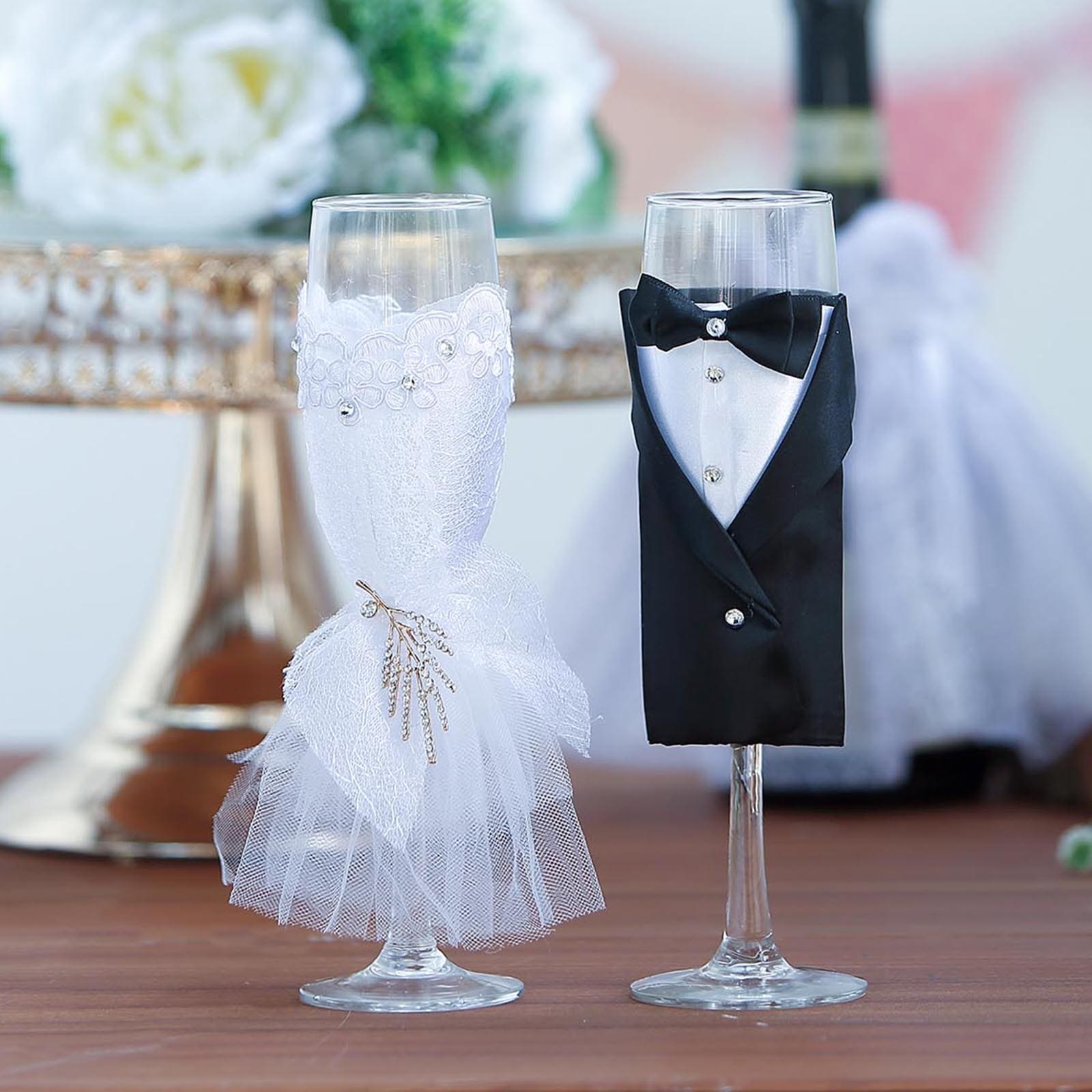 https://tableclothsfactory.com/cdn/shop/products/Black-Bride-Groom-Koozie-Clear-Champagne-Glasses.jpg?v=1689407576