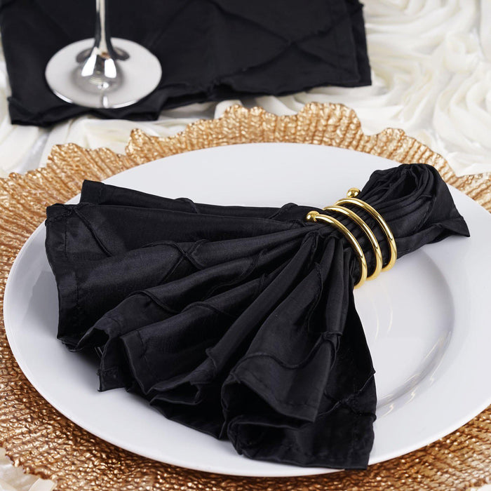 Elegant black napkin with gold ring on a textured placemat.