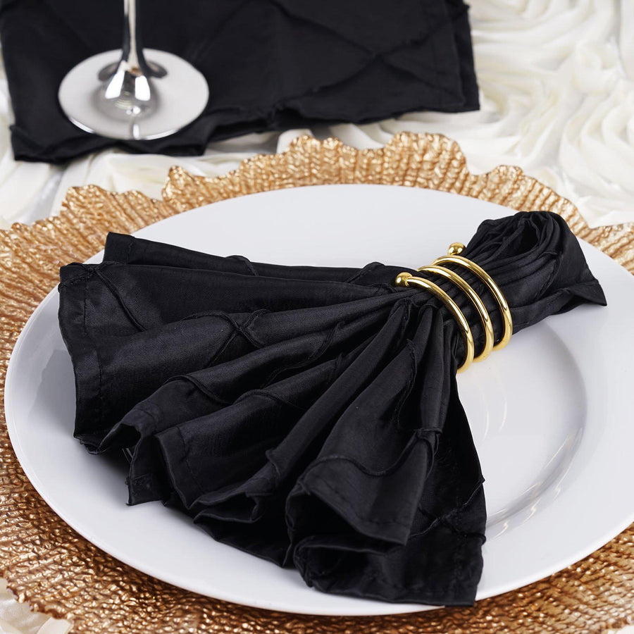 Elegant black napkin with gold ring on a textured placemat.