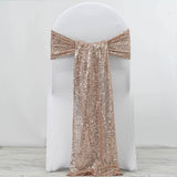 Rose gold sequin chair sash draped on a white chair