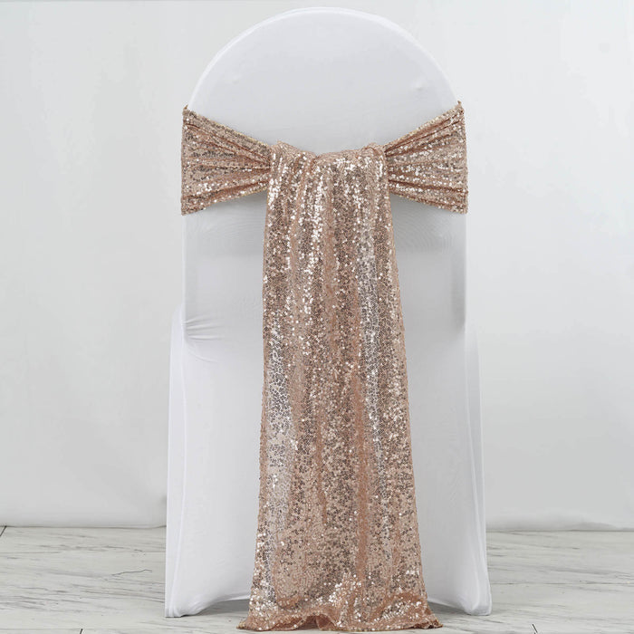 Rose gold sequin chair sash draped on a white chair