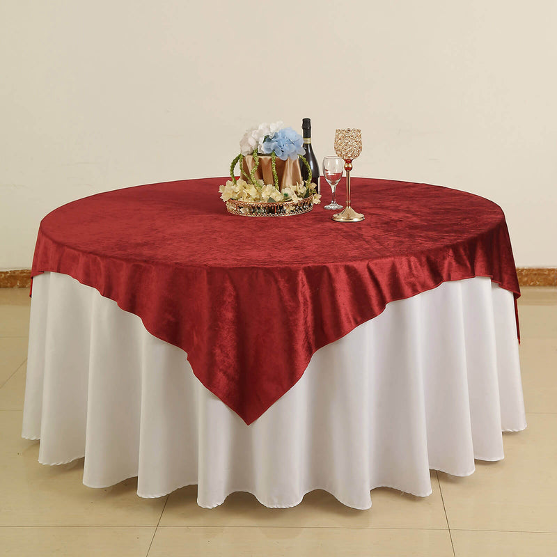 Burgundy velvet table overlay on a round table