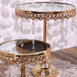 Elegant gold cake stand with hanging crystals and mirror top.