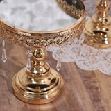 Gold decorative cake stand with crystal accents and mirrored top.