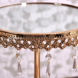 Elegant gold side table with crystal accents and a reflective glass top.