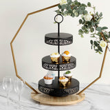 Elegant three-tiered cupcake stand with decorative black holders and floral accents.