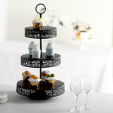Black three-tier dessert stand with cupcakes and decorative treats.