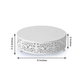 White decorative cake stand with intricate design, 8 inches wide, 2.5 inches tall.