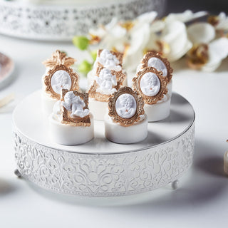 Elegant dessert display with ornate decorations on a decorative white stand.