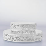 White decorative display stands with intricate cutout designs