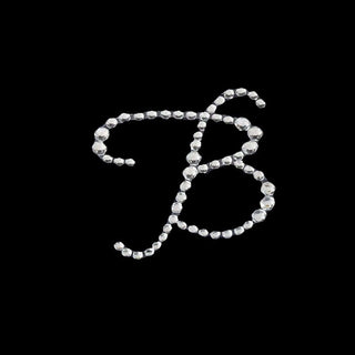 Rhinestone letter B design on a black background.